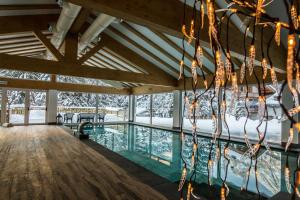 a swimming pool in a house with lights at Residence Cirelle Suite & Spa in Canazei