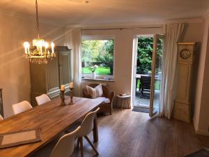 a dining room with a table and chairs and a window at Hyggehus in Humptrup