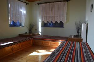 a room with wooden floors and windows and a refrigerator at Petroto house in Fragkades