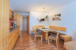 a kitchen and dining room with a table and chairs at Apart Bellevue in Pettneu am Arlberg