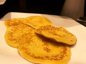 a pile of pancakes on a white plate at Hotel Principe di Piemonte in Rimini