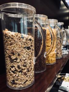 a group of glass jars filled with different types of nuts at Hotel Principe di Piemonte in Rimini