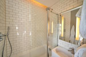 a bathroom with a shower, sink, and tub at Hotel du Vin Exeter in Exeter