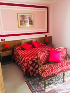 a bedroom with a bed and a couch at Hotel Facioni in Pomezia