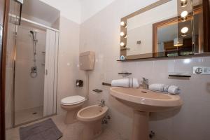 a bathroom with a sink and a toilet and a shower at Villa Margherita in Torri del Benaco