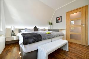 a bedroom with a large bed and a wooden floor at Altstadt Apartment Deluxe in Cottbus