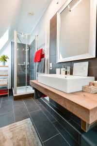 a bathroom with a white sink and a mirror at Altstadt Apartment Deluxe in Cottbus +5 photos