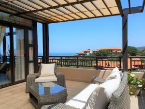 a patio with two chairs and a table at Zimbali Suites 611 in Ballito