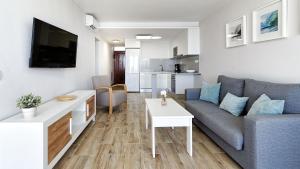 a living room with a couch and a table at Las Nasas by Labranda in Playa del Ingles