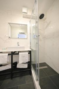 a bathroom with a sink and a glass shower at La Dolce Vita da Zara - Luxury Rooms in Zadar +37 photos