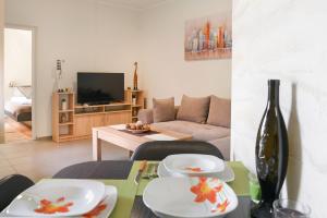 a living room with a table with plates on it at Centar lux 3 in Zrenjanin