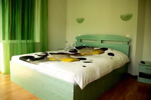 a bedroom with a large bed with white sheets at Ski & Adventure Vila in Azuga