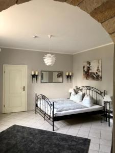a bedroom with a bed and a chandelier at Ferienwohnung am Wasser Villa Graf von Pfeil in Dresden