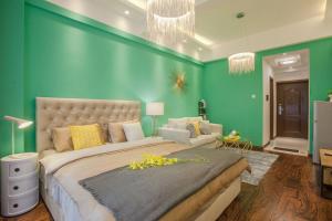 a bedroom with a large bed and a green wall at Chengdu Qingyang·Lihua Street· Locals Apartment 00116030 in Chengdu