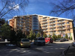 a parking lot in front of a large building at Rivendell Apartments Flora Complex in Borovets