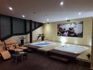 a large bathroom with a jacuzzi tub at Hotel Celjska Koca in Celje