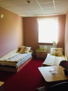 a hotel room with two beds and a table at Zajazd Hubus in Grabowo-Olszewo +21 photos
