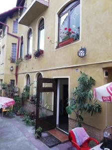 a building with a door open on the side of it at Casa Tătar in Braşov