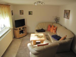 a living room with a couch and a table at Ferienwohnung Schade in Hohnstein