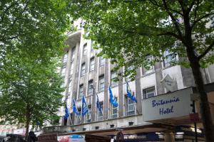 a building with blue flags in front of it at Britannia Hotel Birmingham New Street Station Birmingham in Birmingham