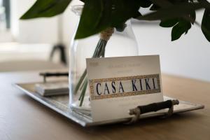 a book sitting on a table next to a vase at Casa Kiki in Ferragudo