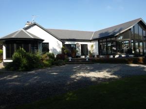 a large white house with a lot of windows at ocean view in Wexford