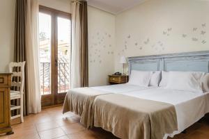a bedroom with a large bed and a window at YIT Puerta Bisagra in Toledo