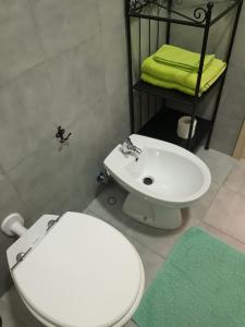 a bathroom with a white toilet and a sink at Apartment in Salerno Centro in Salerno