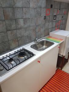 a kitchen with a stove and a sink at Apartment in Salerno Centro in Salerno