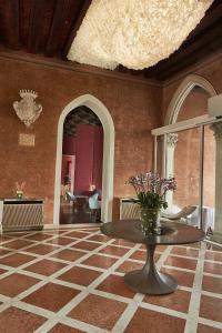 
a large room with a stone wall and a large mirror at Sina Centurion Palace in Venice

