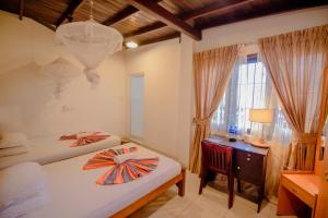 Postel nebo postele na pokoji v ubytování Muhsin Villa - Galle Fort + 37 fotografií