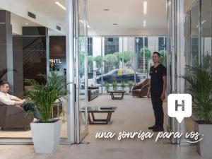 a man standing in the lobby of a building at HTL City Baires in Buenos Aires