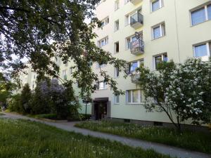 a large white building with a sidewalk in front of it at mika rooms - 22 Korotynskiego Street in Warsaw