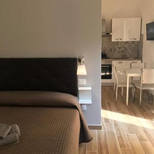 a bedroom with a bed and a kitchen with a table at Santa croce,14 apartments in Bologna