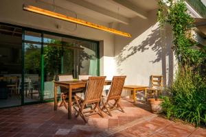 a wooden table and chairs on a patio at Casa Creu in Sant Feliu de Guixols