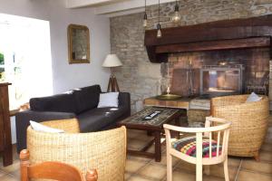 a living room with a couch and a fireplace at La Maison aux Volets Bleus de Prat An Ilis à 900m de la plage du Guilvinec in Le Guilvinec +11 photos