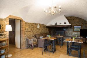 a living room with tables and chairs and a couch at Mas Tomas in Vall-Llobrega