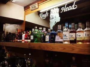 a bar with a lot of bottles of alcohol at King's Head Inn in Llangennith