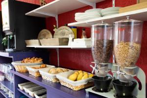 a kitchen with a bunch of food on a shelf at Audotel in Carcassonne