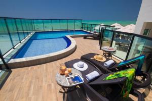 a balcony with a swimming pool on top of a building at Pousada dos Jangadeiros in Maragogi