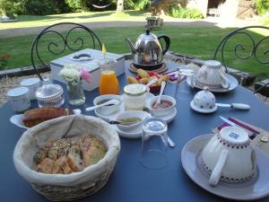 a blue table with food and a tea pot on it at La Longere De Cabanes in Cabanès