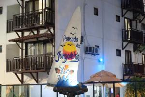 a large white surfboard on the side of a building at Pousada dos Jangadeiros in Maragogi