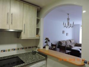 a kitchen with a counter top and a living room at 29 Calle Cártama in La Cala de Mijas