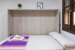 マラガにあるLoft in city centerのベッドルーム1室(大きな白いベッド1台、タオル付)