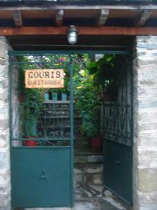 a green door with a sign that reads courts extremists at Guesthouse Gouris in Tsepelovo