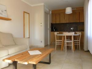 a living room with a couch and a table at Domaine du Ferret Restaurant & Spa in Cap-Ferret
