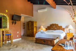 a bedroom with a bed and a tv at Casa Virgilios B&B in Nuevo Vallarta