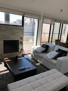 a living room with a couch and a fireplace at Penthouse 603 in Montevideo
