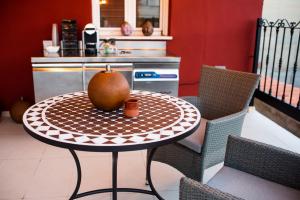 a table with a pear on top of it in a kitchen at Apartamentos Massò in Albacete