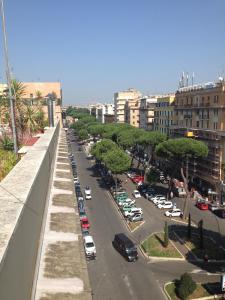 a city street with cars parked in a parking lot at Domus Appia 154 B&B in Rome